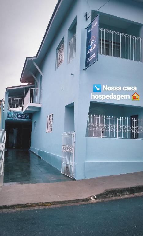 a building with a sign on the side of it at Nossa Casa in Cunha