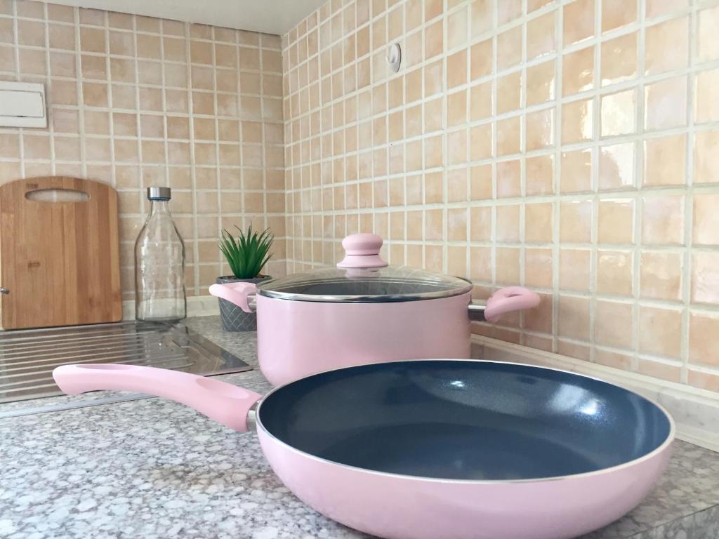a pink bowl on a counter with a pot at Minimal Apartment Center Kavala in Kavála