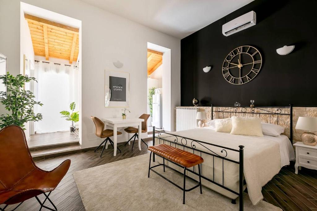 a bedroom with a large bed and a clock on the wall at Royal Piazza di Spagna in Rome