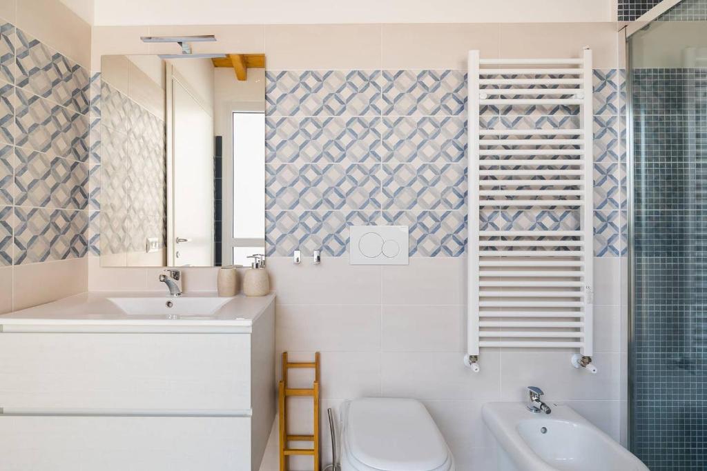 a bathroom with a sink and a toilet and a shower at Royal Piazza di Spagna in Rome