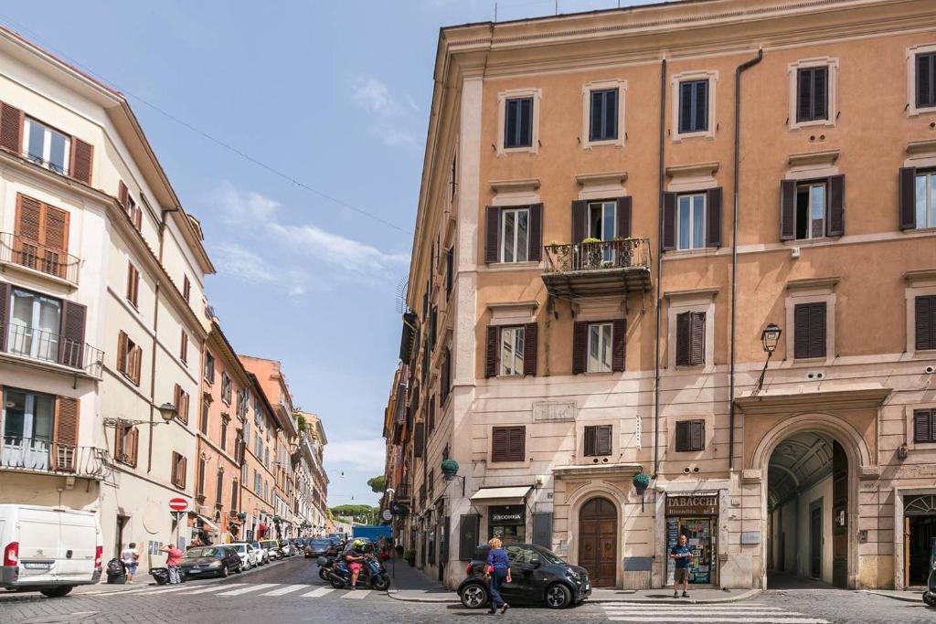 a street in a city with buildings and cars at Royal Piazza di Spagna in Rome