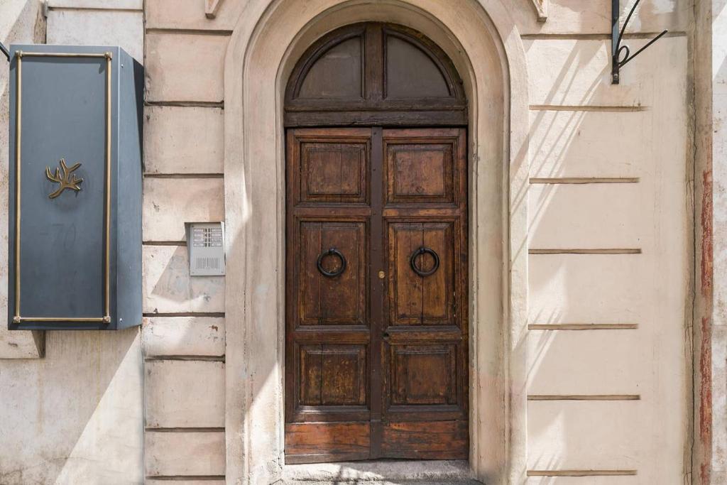a wooden door on the side of a building at Royal Piazza di Spagna in Rome
