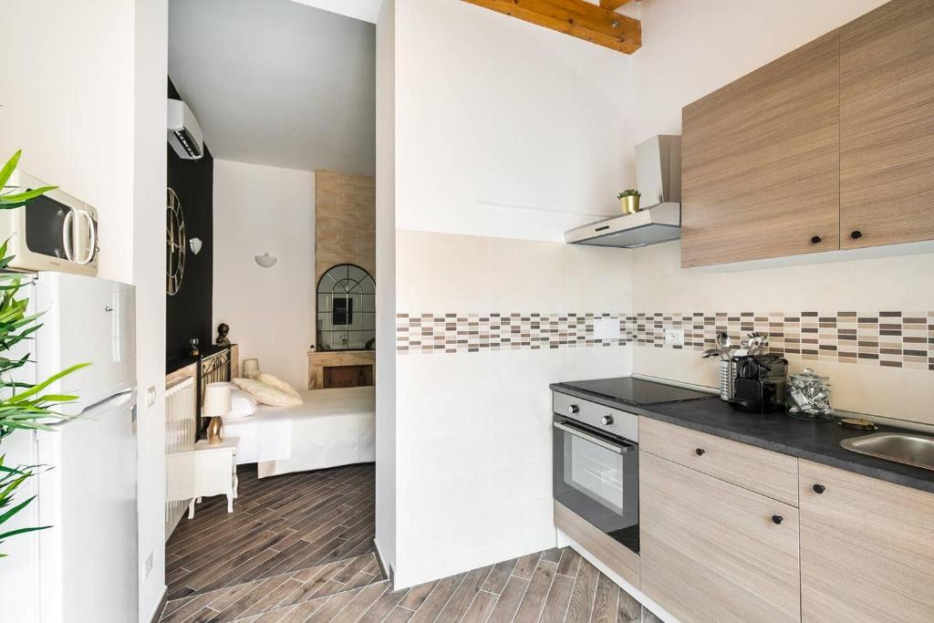 a kitchen with white walls and wooden cabinets at Royal Piazza di Spagna in Rome