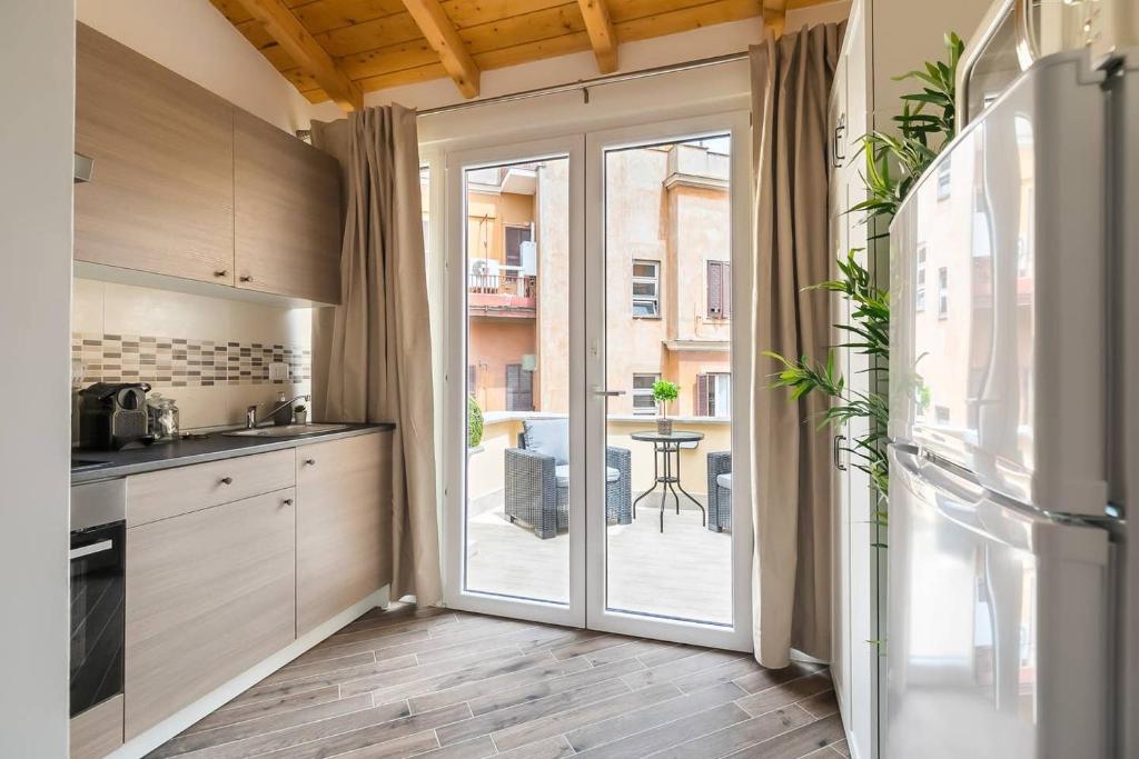 a kitchen with a sliding glass door to a patio at Royal Piazza di Spagna in Rome