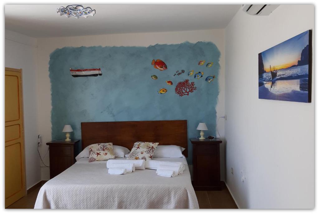 a bedroom with a bed with towels on it at Casa Giavada in Sciacca