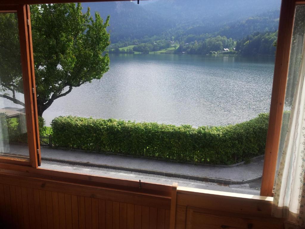 a view of a lake from a window at Appartements direkt am See in Grundlsee