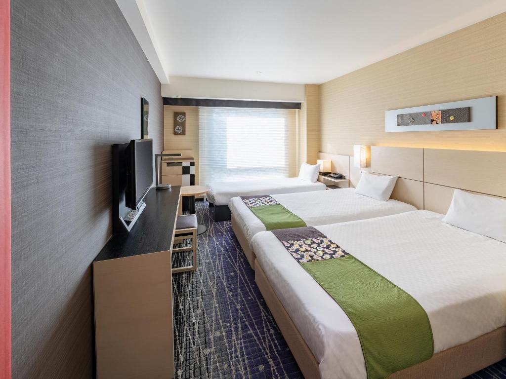 Postel nebo postele na pokoji v ubytování Hotel New Hankyu Kyoto