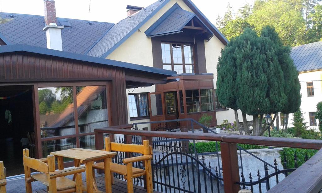 a house with a deck with a table and chairs at Ubytování U Bohouše in Jilemnice