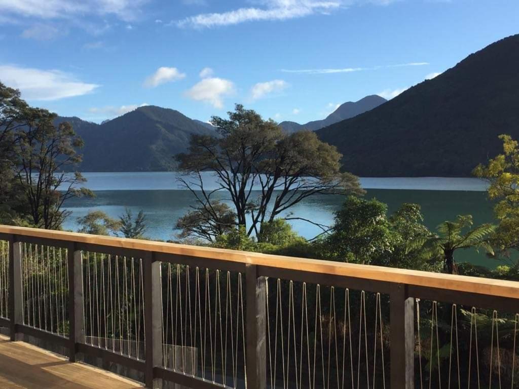 a view of a lake from the deck of a house at Marlborough Sounds Accommodation in Havelock
