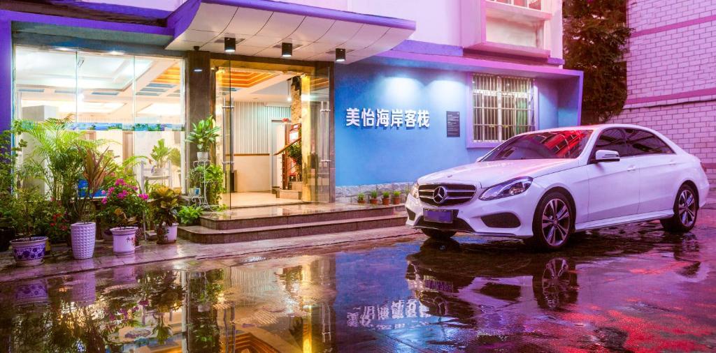 a white car parked in front of a building at Sanya Tropical Coast Hotel in Sanya