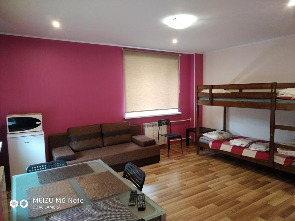 a living room with a couch and bunk beds at Sparta Apartments Bastrakovi in Narva