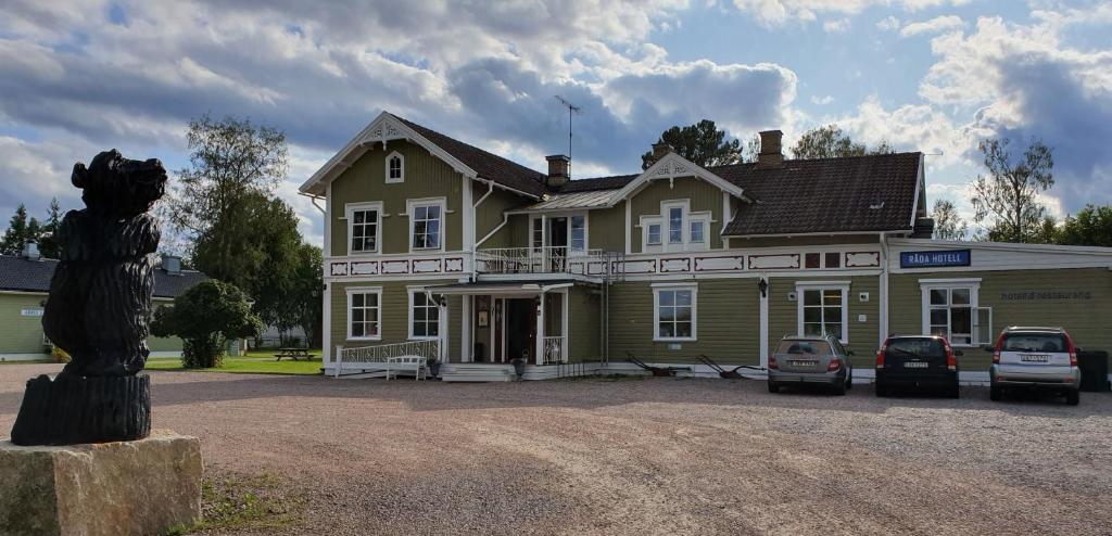 a large house with cars parked in front of it at Råda Hotel in Hagfors