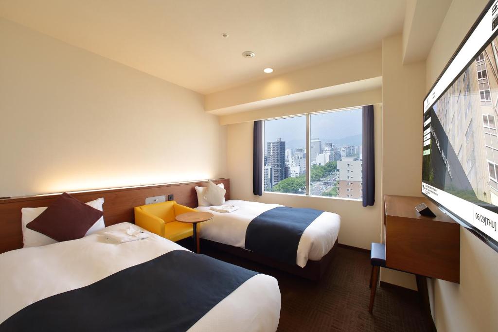 Postel nebo postele na pokoji v ubytování Oriental Hotel Hiroshima