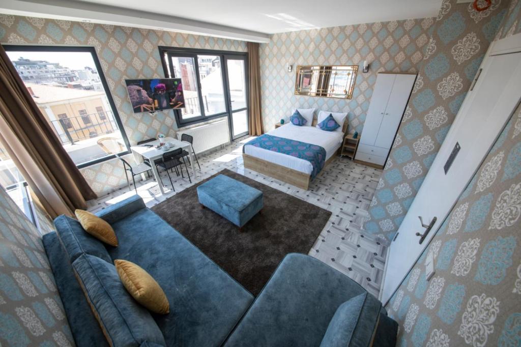 a hotel room with a bed and a couch at ROYAL TAKSIM SUITES in Istanbul