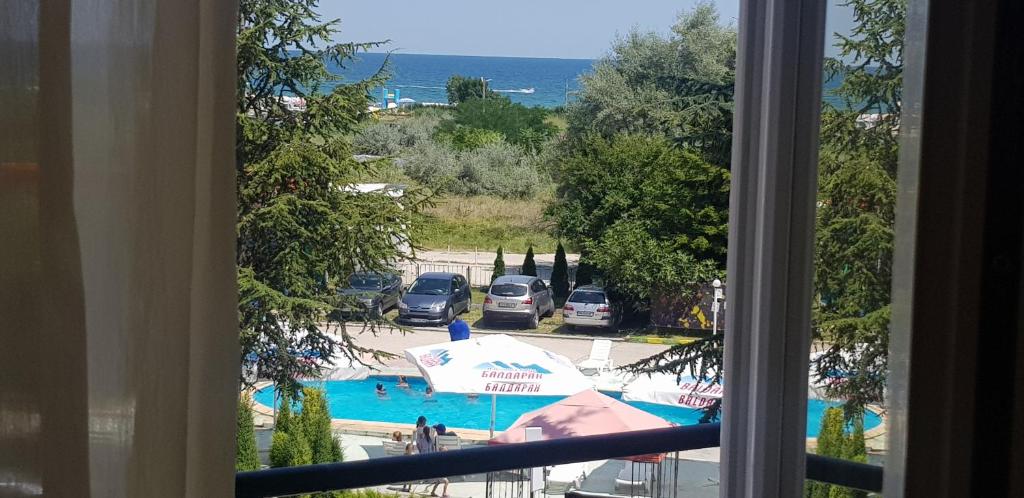a view of a swimming pool from a window at DSK Hotel in Kranevo