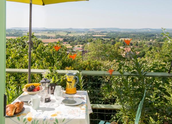 a table with a plate of food and a bowl of fruit at 39 Tour de Ville in Monflanquin