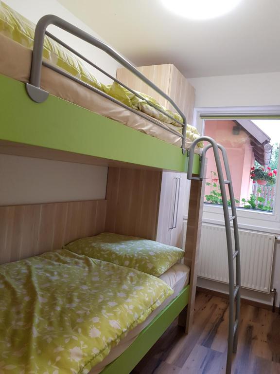 a bunk bed in a room with a bunk bed in a room at Apartments Mojstrana - Kekec in Mojstrana