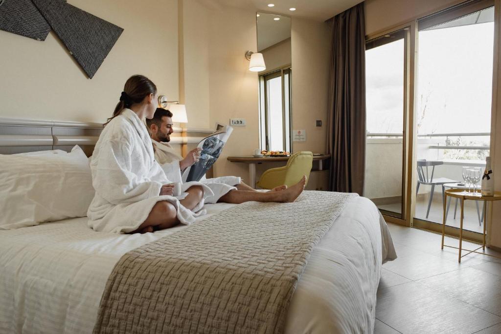 Postel nebo postele na pokoji v ubytování Emmantina Hotel