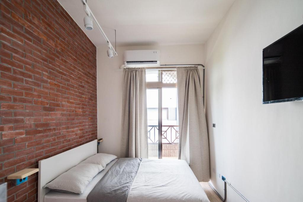Postel nebo postele na pokoji v ubytování Dongshan Yi Hostel