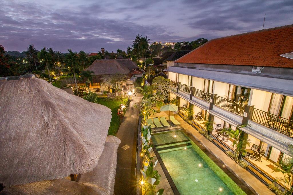 an aerial view of a building with a swimming pool at Kamandhani Cottage in Ubud