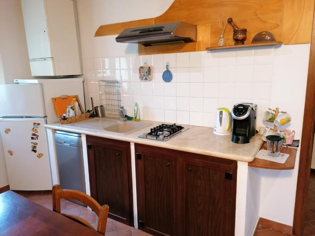 a kitchen with a sink and a stove and a refrigerator at Panorama di Siena in Siena
