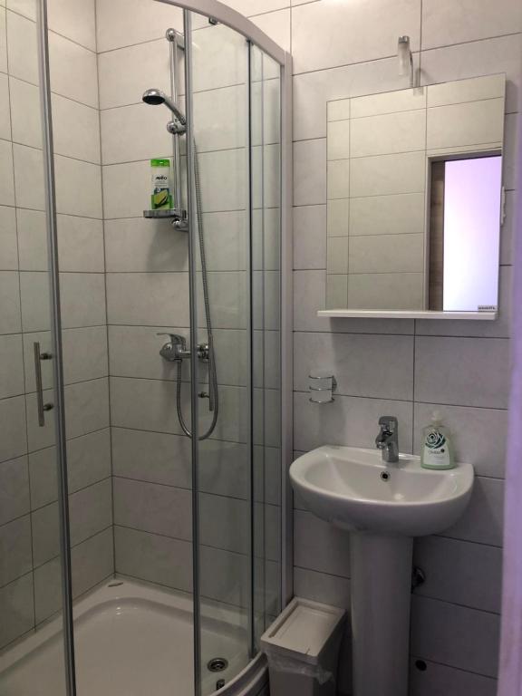 a bathroom with a shower and a sink and a toilet at Apartments & Rooms Nardin in Izola