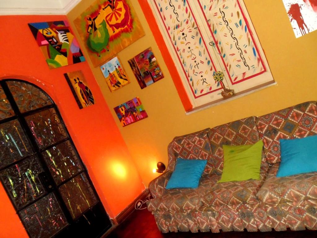 ein Wohnzimmer mit Sofa und Bildern an der Wand in der Unterkunft Arte Brasileira in Salvador