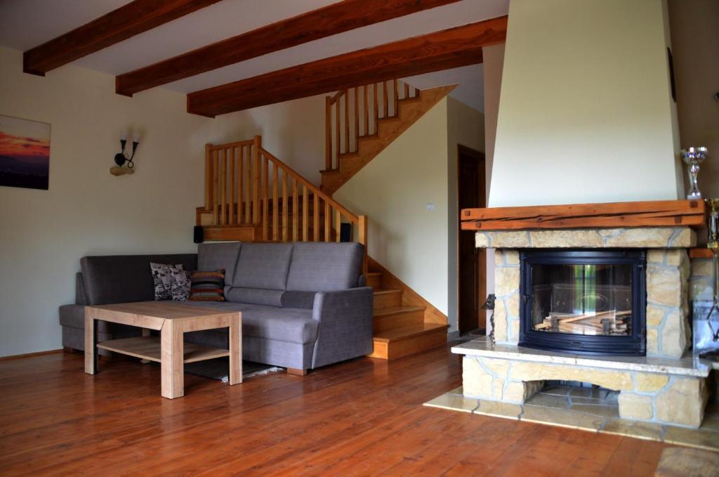 a living room with a couch and a fireplace at Dom w Beskidach in Stryszawa