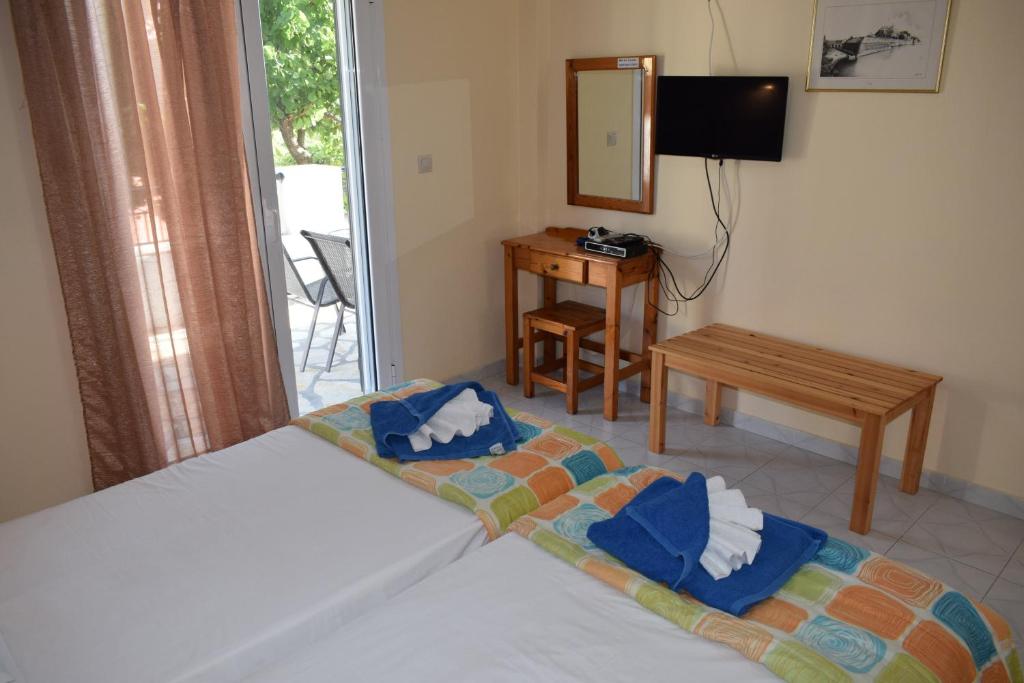 a bedroom with a bed with towels on it at Sea View in Paleokastritsa