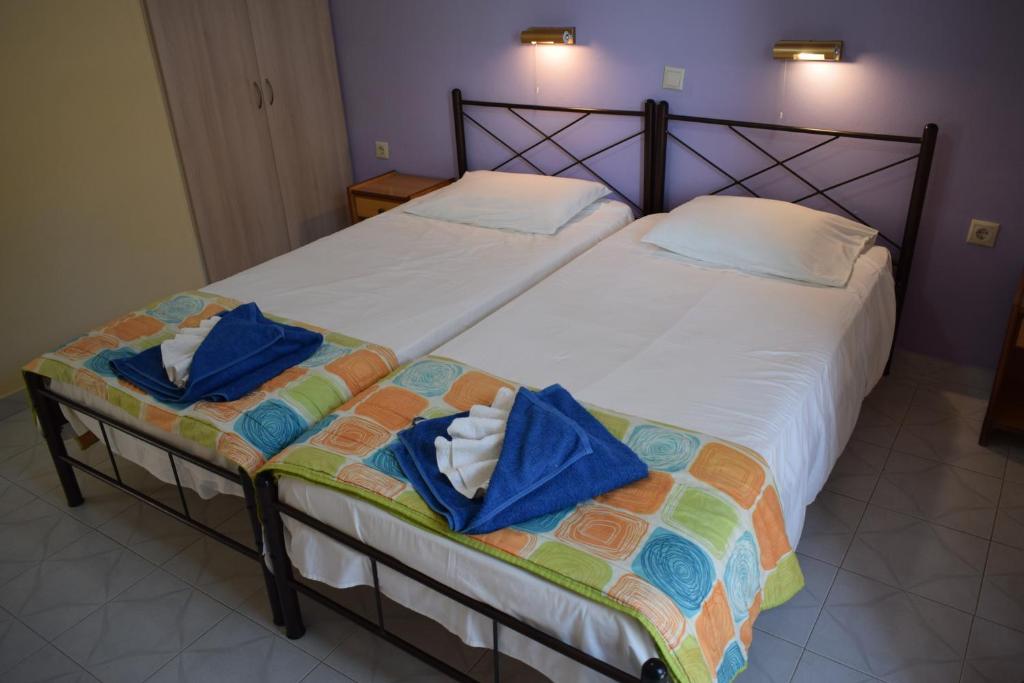 two twin beds in a room with towels on them at Sea View in Paleokastritsa