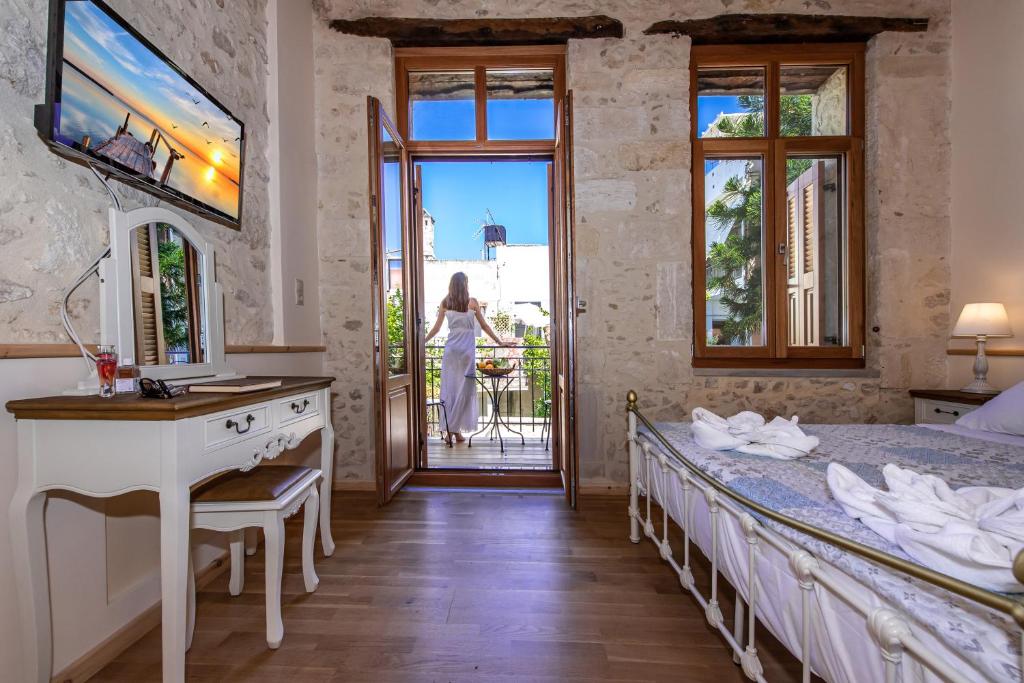 a bedroom with a bed and a desk and a window at Villa Casa Atitamo in Rethymno Town