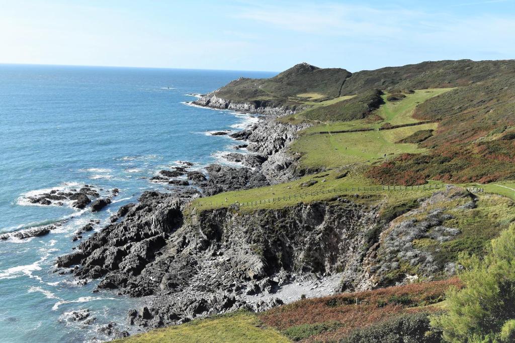 a view of the ocean and a rocky coastline at Watersmeet Hotel in Woolacombe