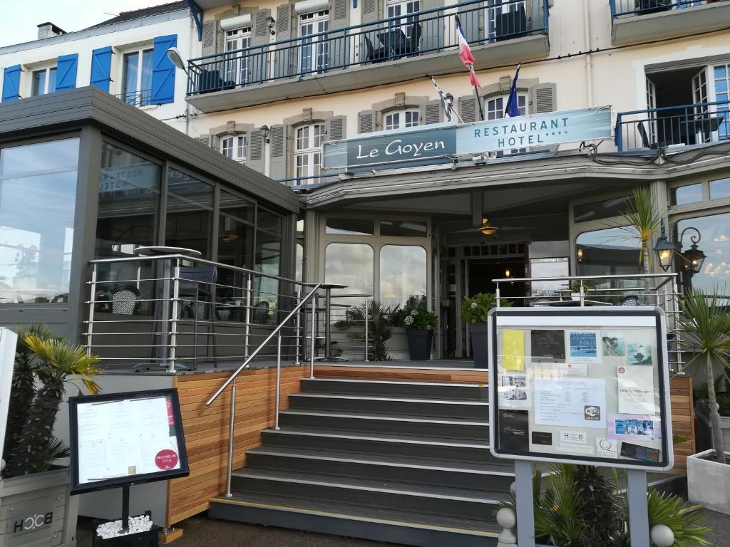 un bâtiment avec des escaliers en face d'un bâtiment dans l'établissement Logis hôtel restaurant Le Goyen, à Audierne