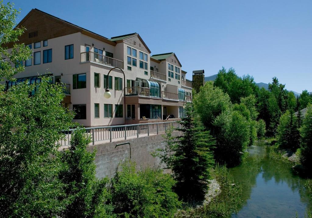 a building on a bridge next to a river at Mountain House by Keystone Resort in Keystone