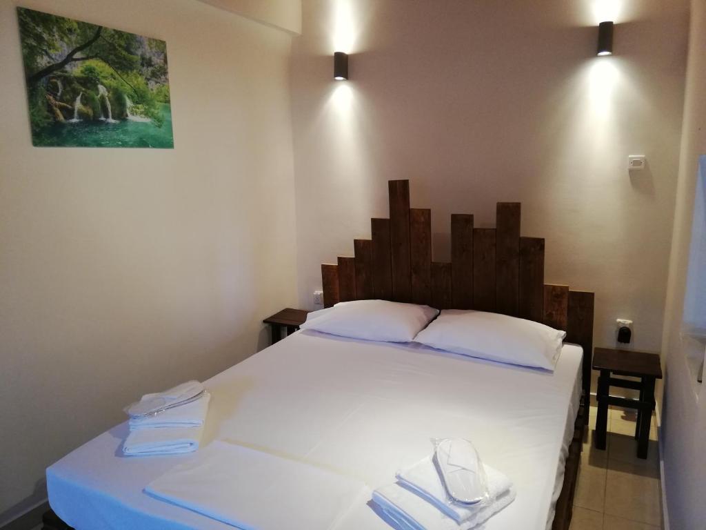a bedroom with a large white bed with two towels at Dreamhome -10min from airport- in Artemida