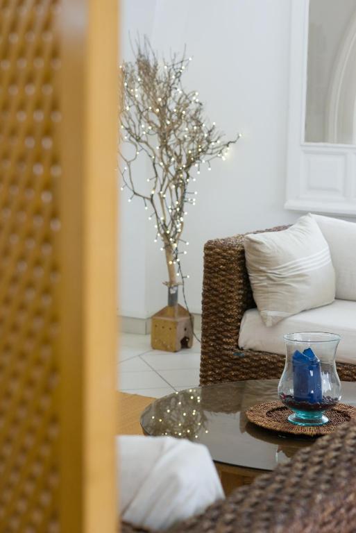 a living room with a couch and a table at Villa Phoenicia in Hammamet