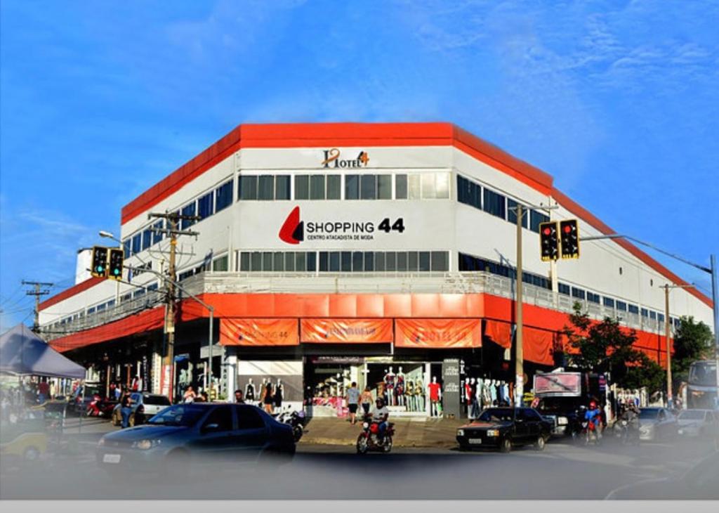 a building on a street with cars parked in front of it at HOTEL 44 in Goiânia