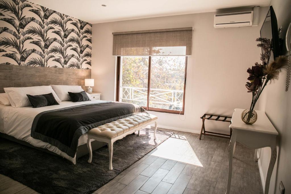 a bedroom with a large bed and a window at Lib Hotel Bellavista in Santiago