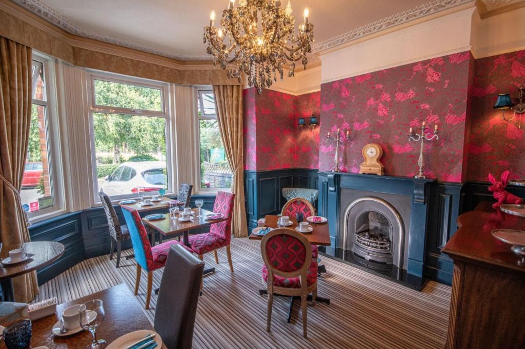 a dining room with red walls and a fireplace at Amarillo in Bournemouth