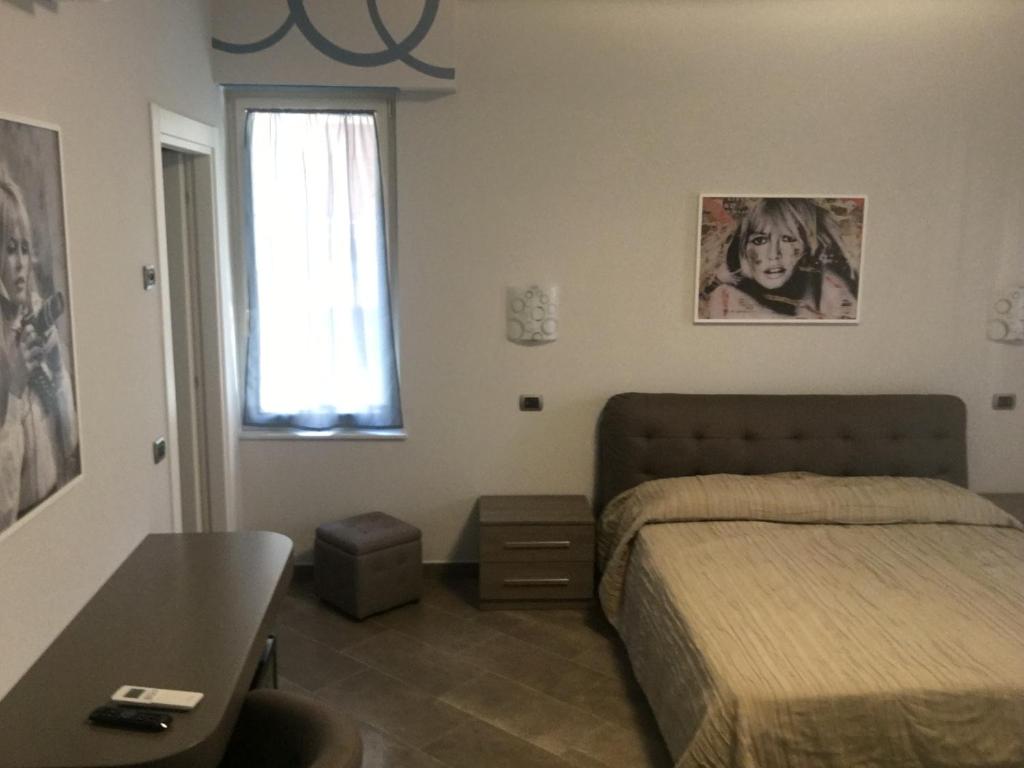 Postel nebo postele na pokoji v ubytování Le Divine di via Olivieri - Reception Via XXV Aprile 5