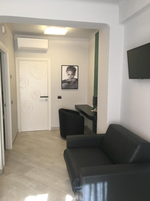 TV a/nebo společenská místnost v ubytování Le Divine di via Olivieri - Reception Via XXV Aprile 5