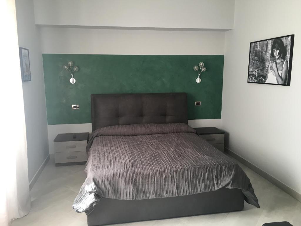Postel nebo postele na pokoji v ubytování Le Divine di via Olivieri - Reception Via XXV Aprile 5