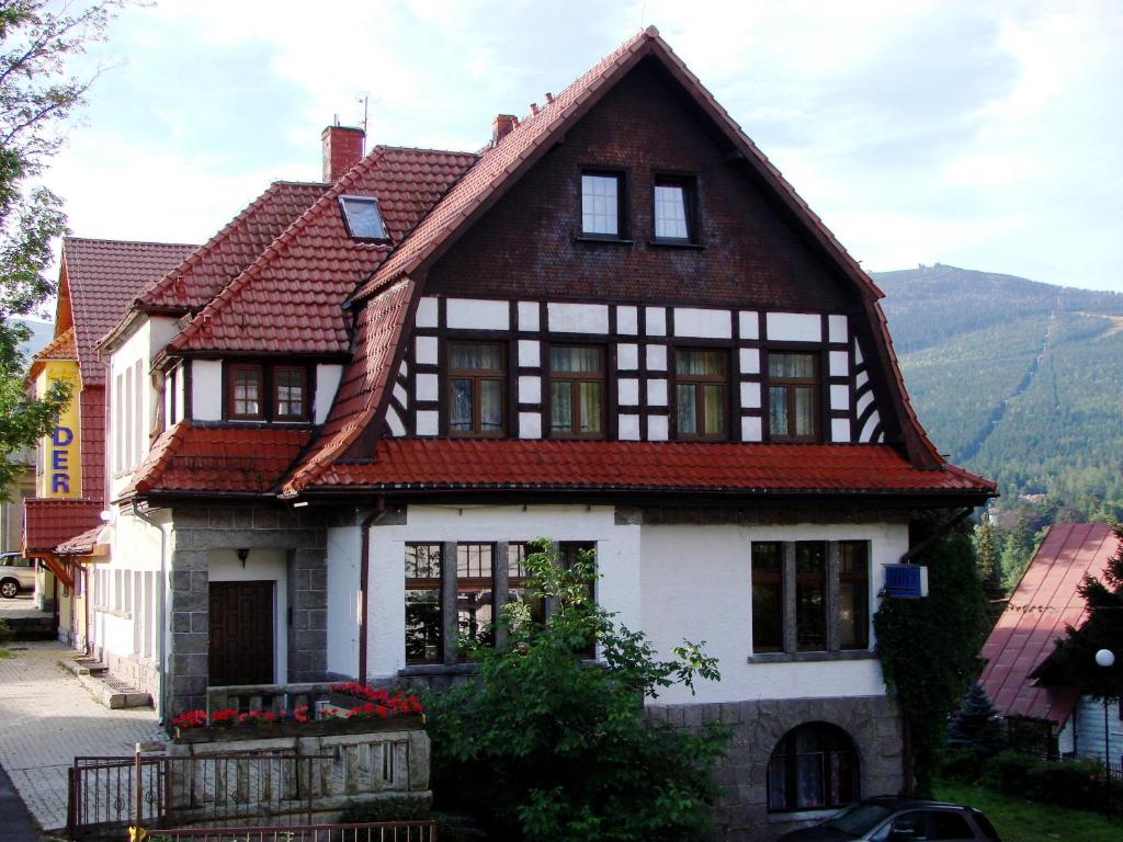 a white house with a red roof at Pensjonat Lider in Szklarska Poręba