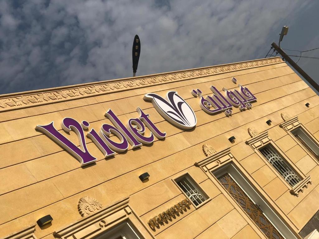 a building with a sign on the top of it at Violette Chalet in Abha