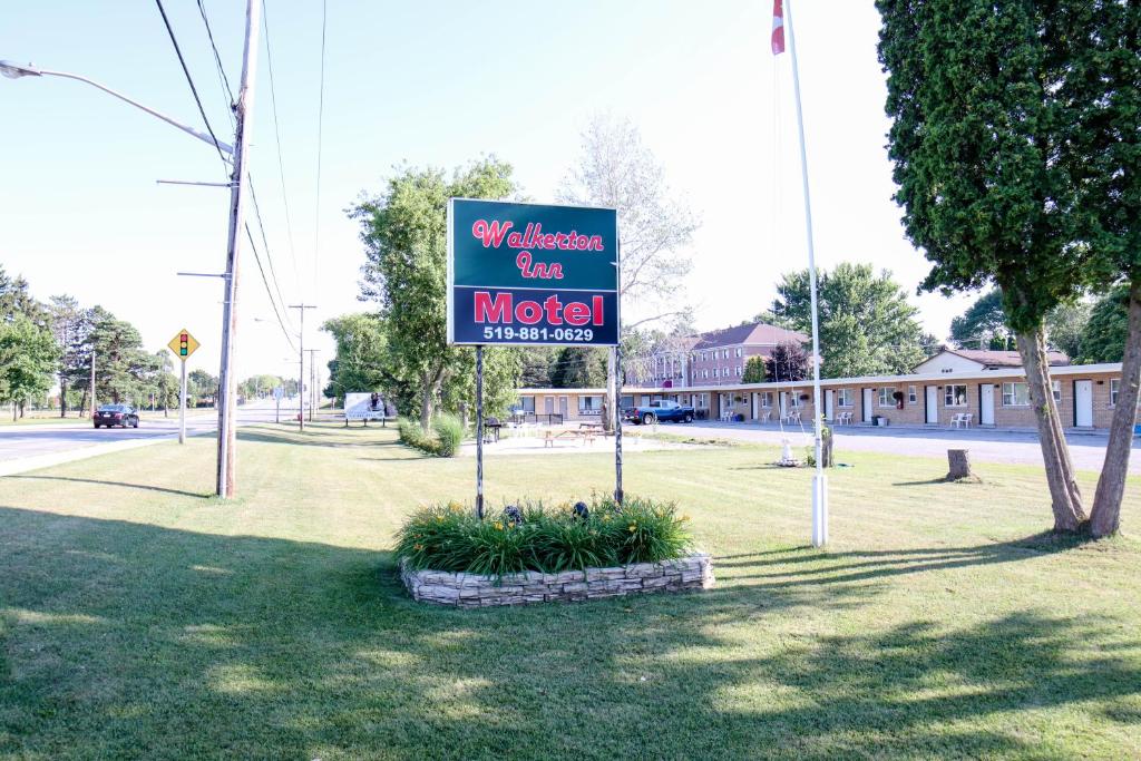a sign for a motel in a park at Walkerton Inn Motel in Walkerton