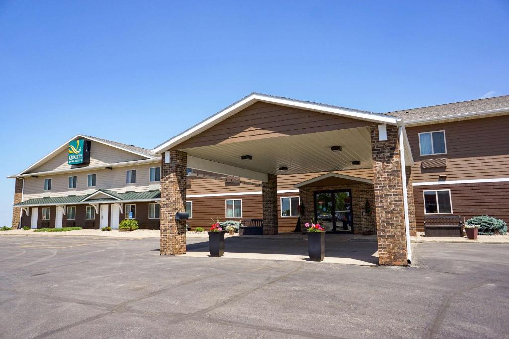 a front view of a hotel with a parking lot at Quality Inn & Suites Watertown in Watertown