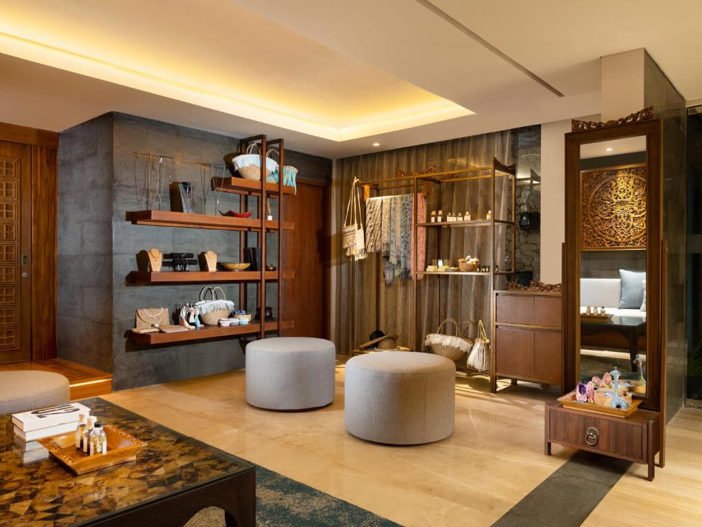 a living room with two stools and a table at Anantara Uluwatu Bali Resort in Uluwatu