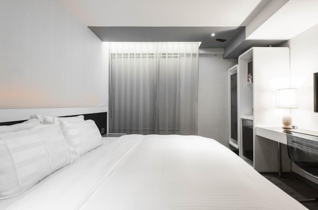 Postel nebo postele na pokoji v ubytování Saual Keh Hotel