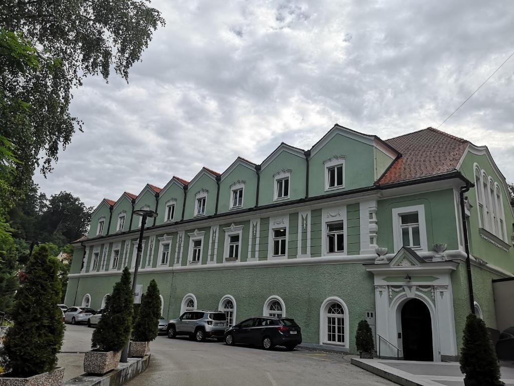 a large building with cars parked in front of it at Apartment Park 16 in Rogaška Slatina