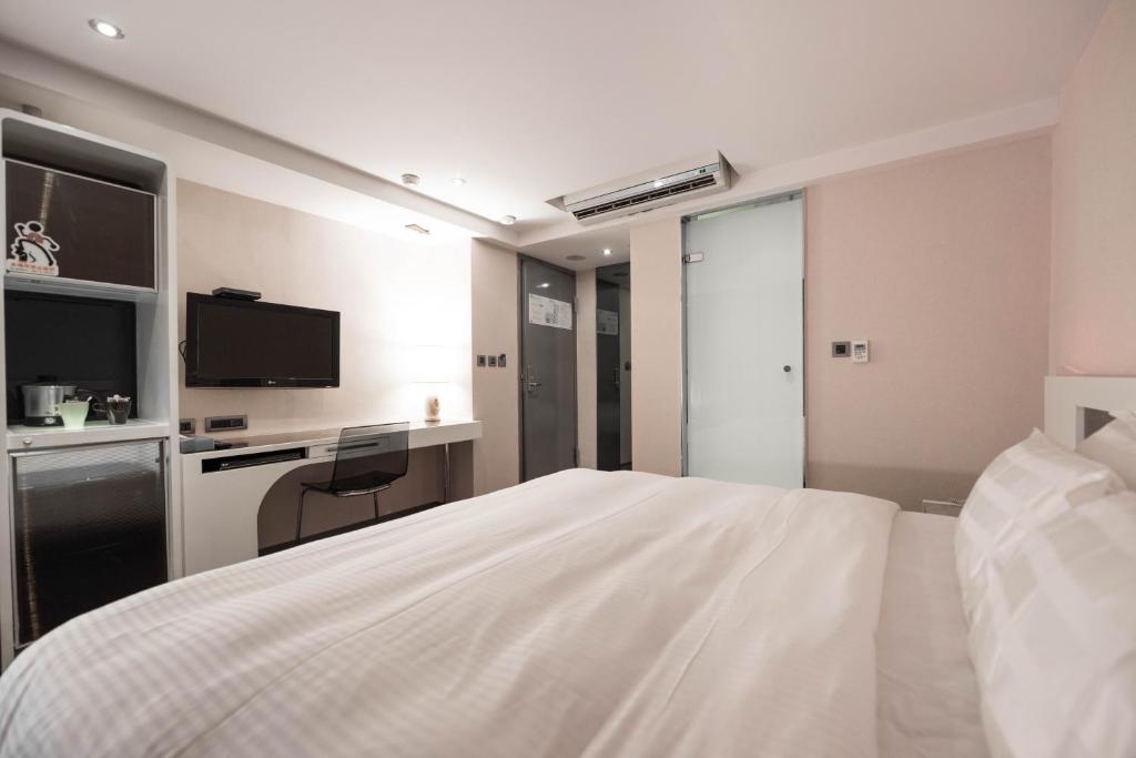 Postel nebo postele na pokoji v ubytování Saual Keh Hotel